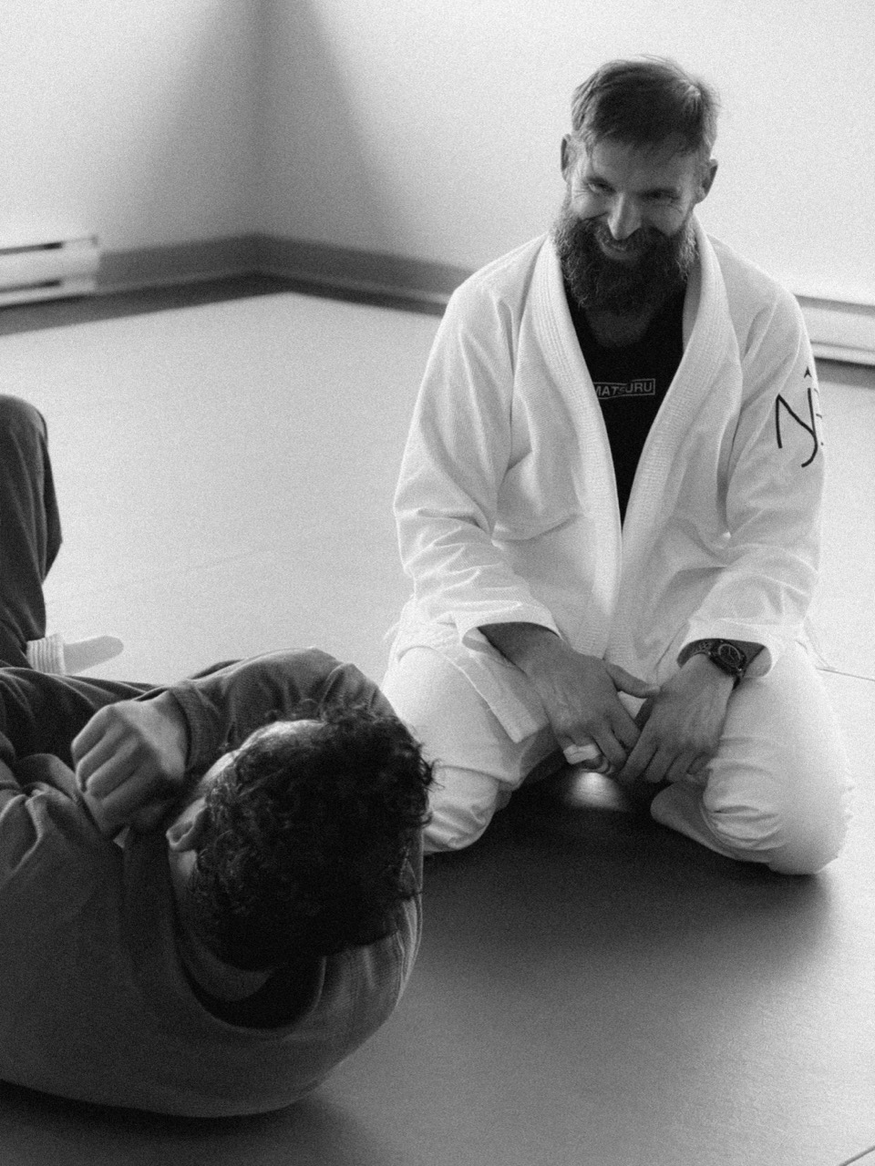 Coach smiling while guiding a student through ground movement